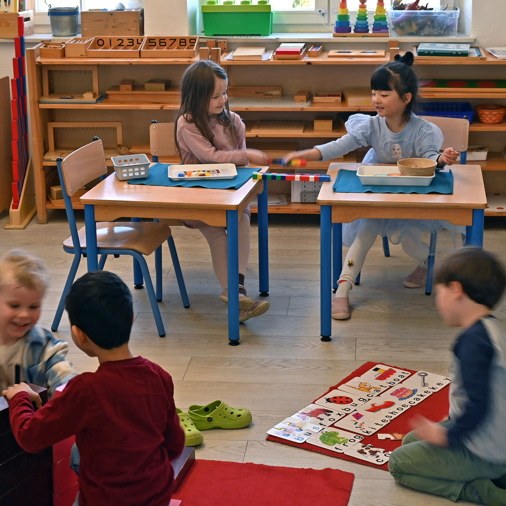 International children playing in Montessori classroom in Munich kindergarten