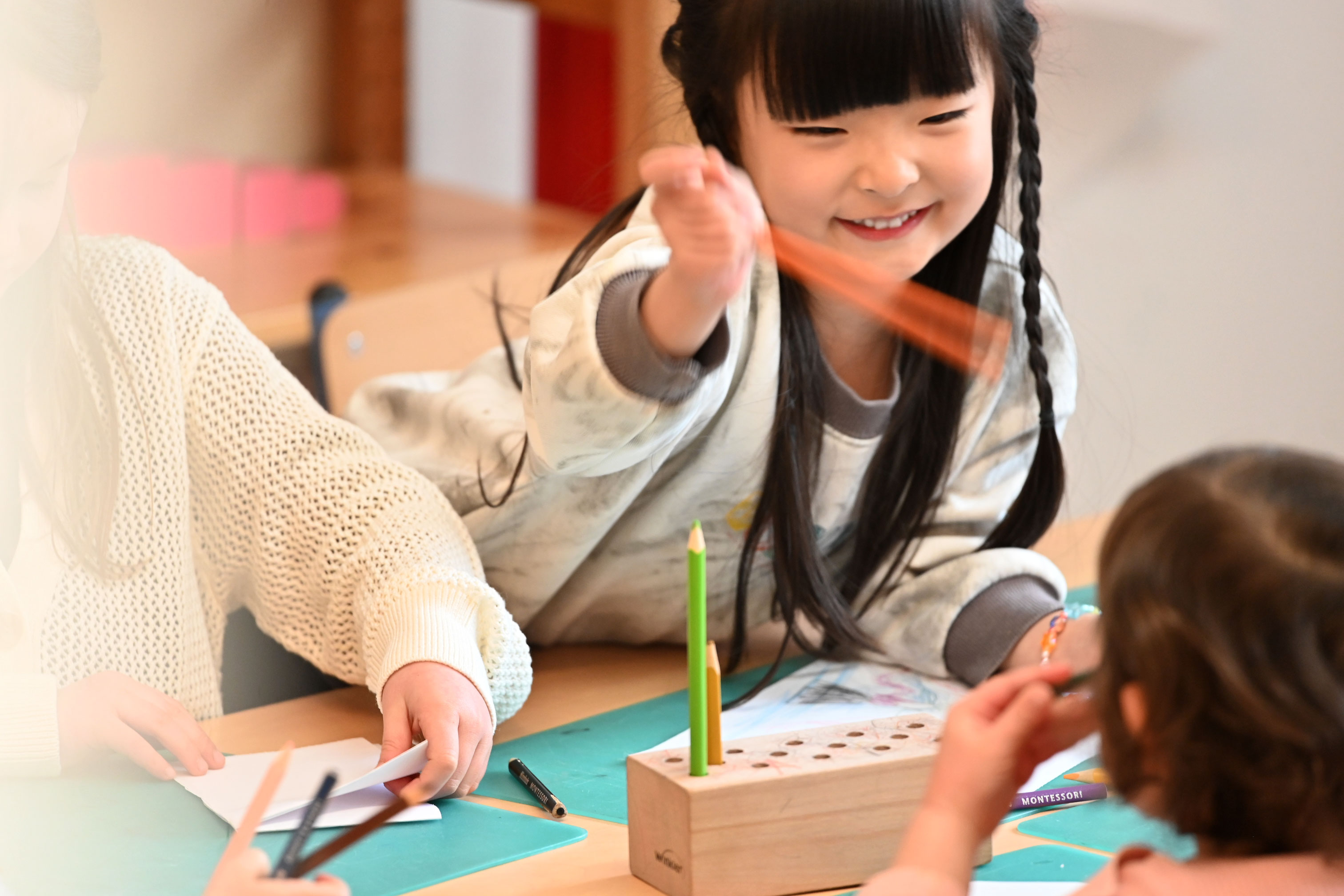 Chinese child doing Montessori in a bilingual kindergarten